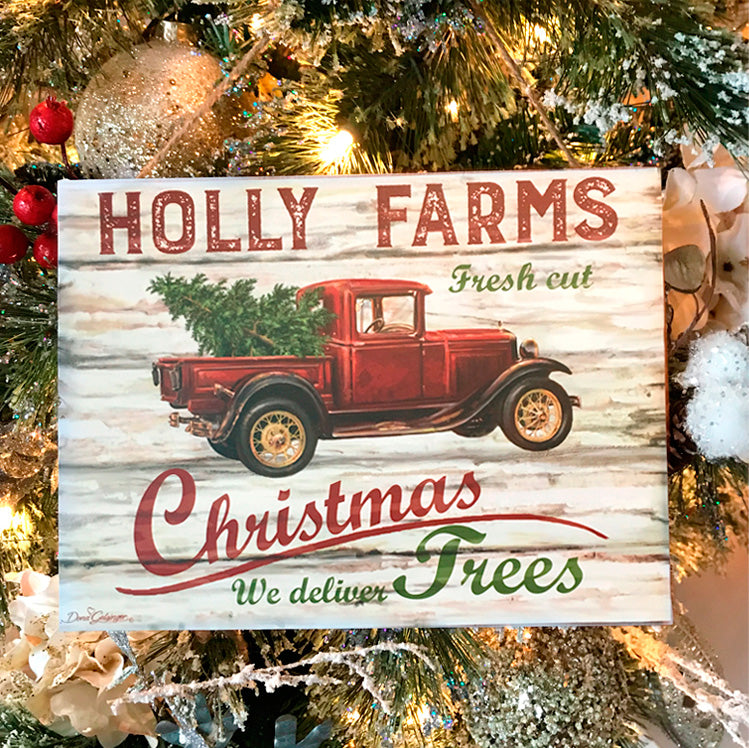  The vintage red truck, adorned with a freshly cut pine tree in its bed, instantly brings to mind memories of long drives through snow-covered hills, hand-in-hand with your beloved.  The sign's message, "Holly Farms fresh cut Christmas trees, we deliver."