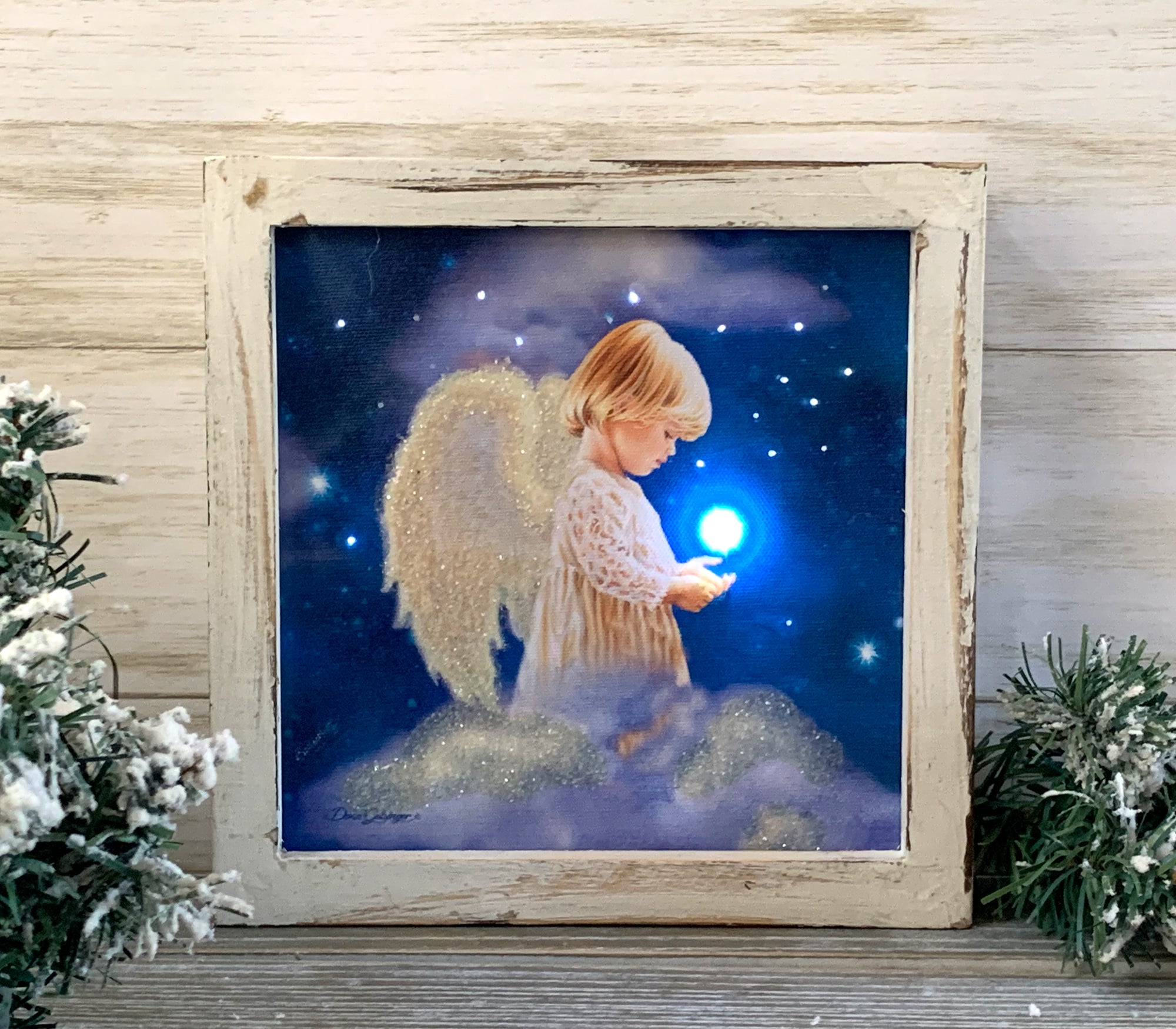 Featuring a young angel with glitter-covered wings and a bright light in her hand, this stunning piece is sure to captivate the heart and inspire the imagination.  With its fiberoptic lights illuminating the background stars, the Angel Star Lighted Shadow Box creates a mesmerizing and dreamlike ambiance that will transport you to a world of romance and magic.