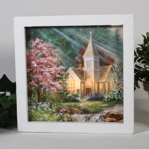 This stunning masterpiece captures the essence of romance and tranquility, as a magnificent chapel stands tall amidst a picturesque landscape of vibrant flowers and flowing streams.  The intricate details of the chapel and its surroundings are carefully crafted to transport you to a world of natural beauty and serenity. The colorful flowers and vibrant tree in the front yard create a stunning contrast against the charming white chapel.