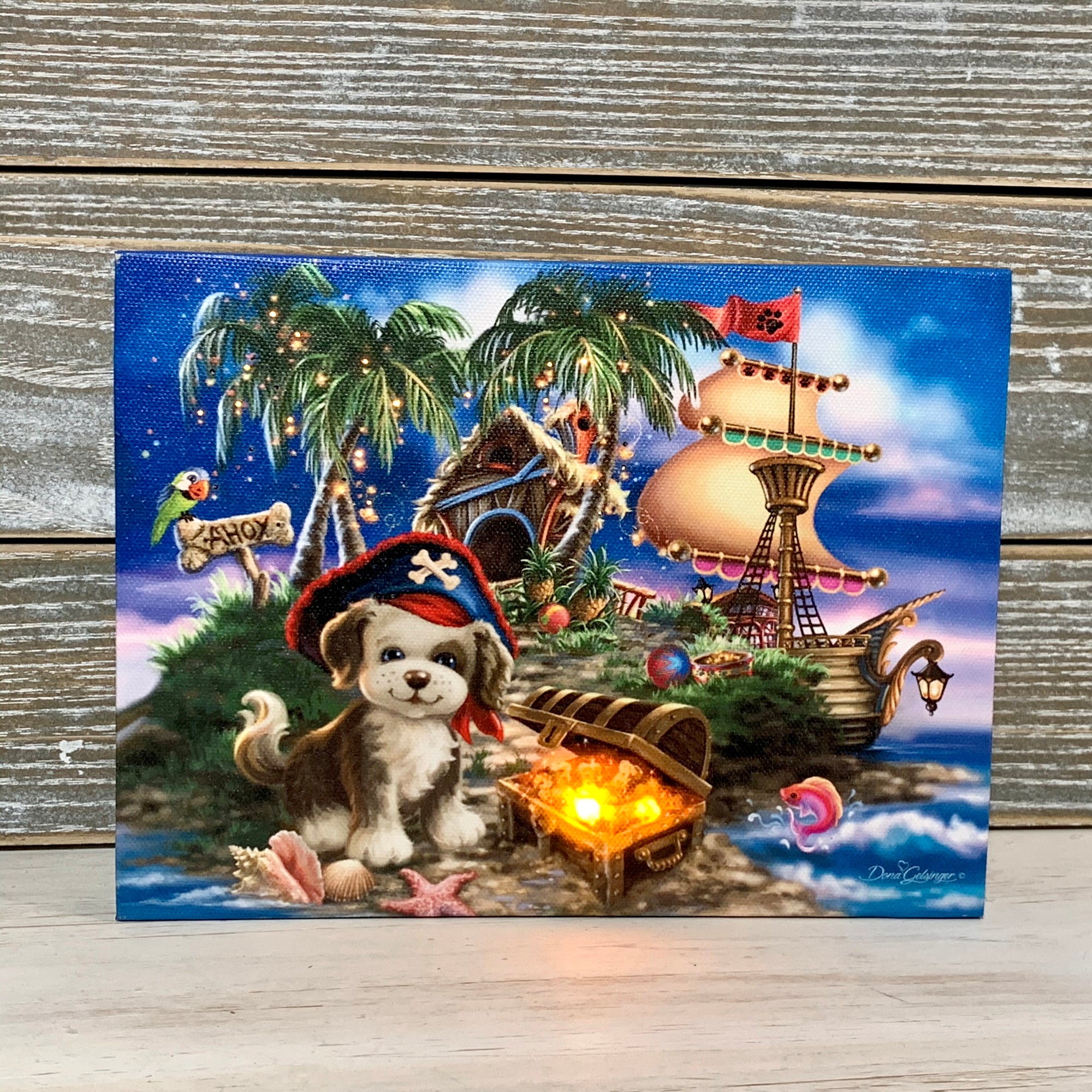  This delightful canvas features a charming puppy wearing a pirate's hat, standing next to a treasure chest overflowing with golden coins. The perfect addition to any room, this canvas will transport you to a tropical island, complete with palm trees, a cozy hut, and a trusty pirate ship in the background.