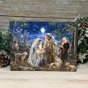  This beautifully crafted nativity scene captures the essence of the season with its depiction of Mary and Joseph gazing lovingly at their newborn baby Jesus, surrounded by a young boy and gentle lambs.  The LED lights embedded in the canvas create a warm and inviting glow that illuminates the bright shining star guiding the wise men on their journey to pay homage to the newborn king.