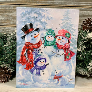 This enchanting canvas depicts a heartwarming scene of a mom and dad snowman embracing their little ones, holding a baby snowman close while a young snowman beams with happiness in front of them. And that's not all - even a playful snow puppy has found a place in this snowy wonderland, adding an extra touch of whimsy and delight.