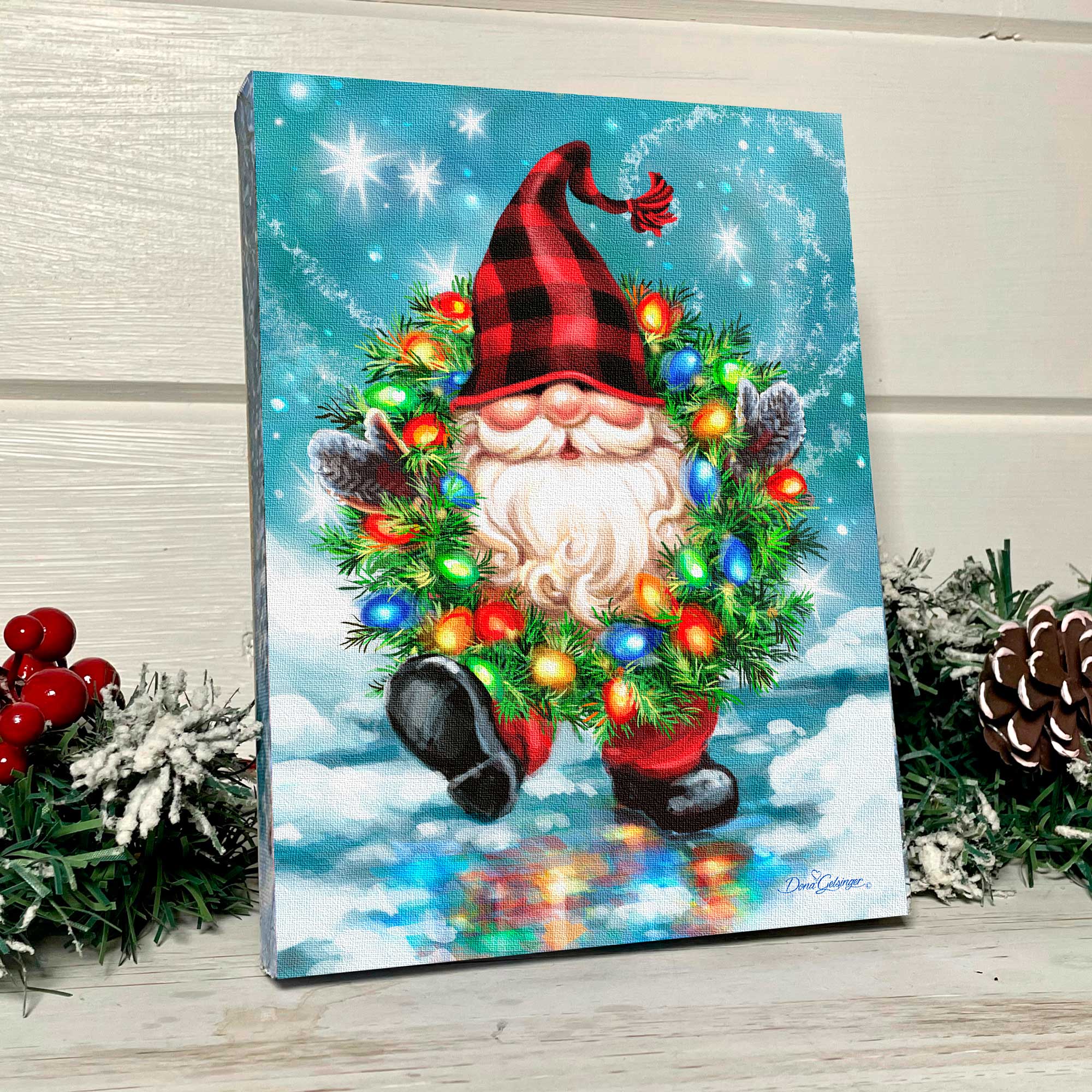 This charming 8x6 canvas showcases a jolly gnome, decked out in a festive plaid beanie and boasting a long, full white beard that exudes warmth and merriment.  But that's not all - this delightful gnome is also adorned with a colorful wreath, wrapped snugly around his neck and illuminated by twinkling LED lights.