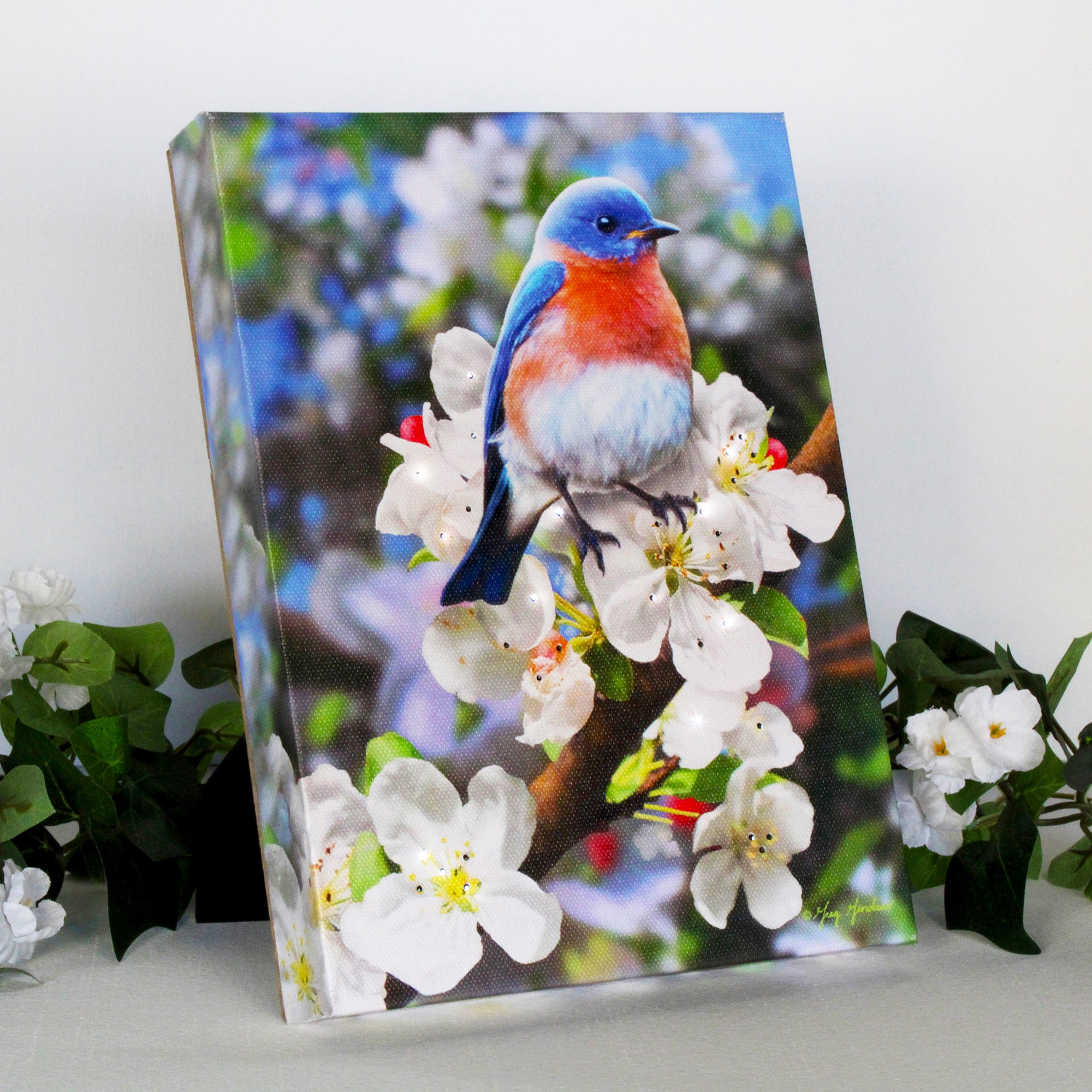 Featuring a delicate bluebird perched on a blooming branch, this enchanting piece will capture your heart and add a touch of elegance to any room.