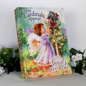 This captivating canvas features a young angel with shimmering wings, standing on her tippy toes to gaze upon two vibrant cardinals perched on a charming birdhouse. The forest scene is bursting with colorful blooms, creating a serene and inviting atmosphere.