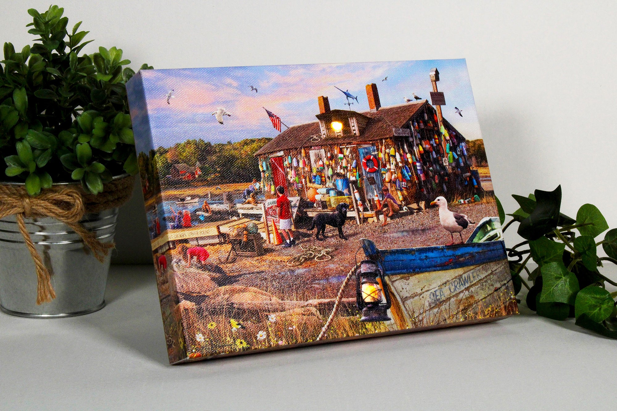 Adorned with buoys tied all over the outside walls, this charming canvas captures the essence of a quintessential lobster shack by the shore. Watch as children frolic along the sandy beach, while others enjoy the serene setting of the dock.