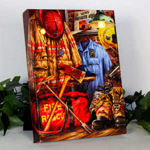 Firefighter gear set up all over a room, including a fire retardant suit, hat, mask, boots, axe, and crowbar, this canvas is the perfect way to show your love and appreciation for the courage and dedication of these heroic first responders.  With the firefighter's bag sitting on the ground and a newspaper up on the wall.