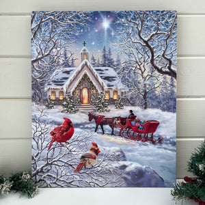 Experience the magic of the holiday season with our A Christmas Journey 16x20 Fiber Optic Canvas. This beautiful piece of art features a stunning red horse-drawn carriage in front of a charming chapel, both illuminated by twinkling fiber optic lights that bring the scene to life.