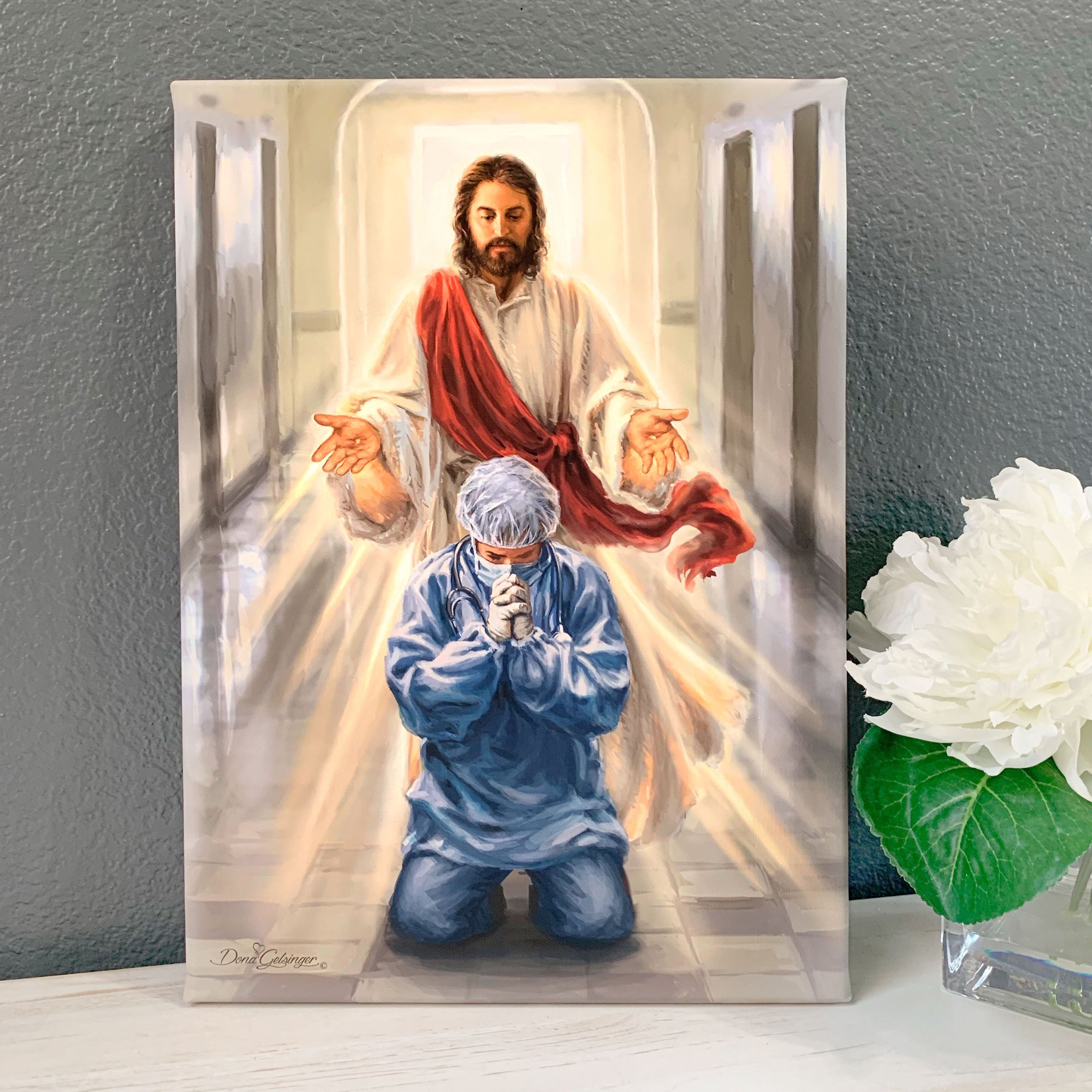 This stunning piece of art captures the essence of hope, faith, and gratitude that we all feel for those who have tirelessly fought on the frontlines of the pandemic.  With Jesus standing in the background, arms wide open, this canvas beautifully depicts the support and comfort that our healthcare workers receive from a higher power. 