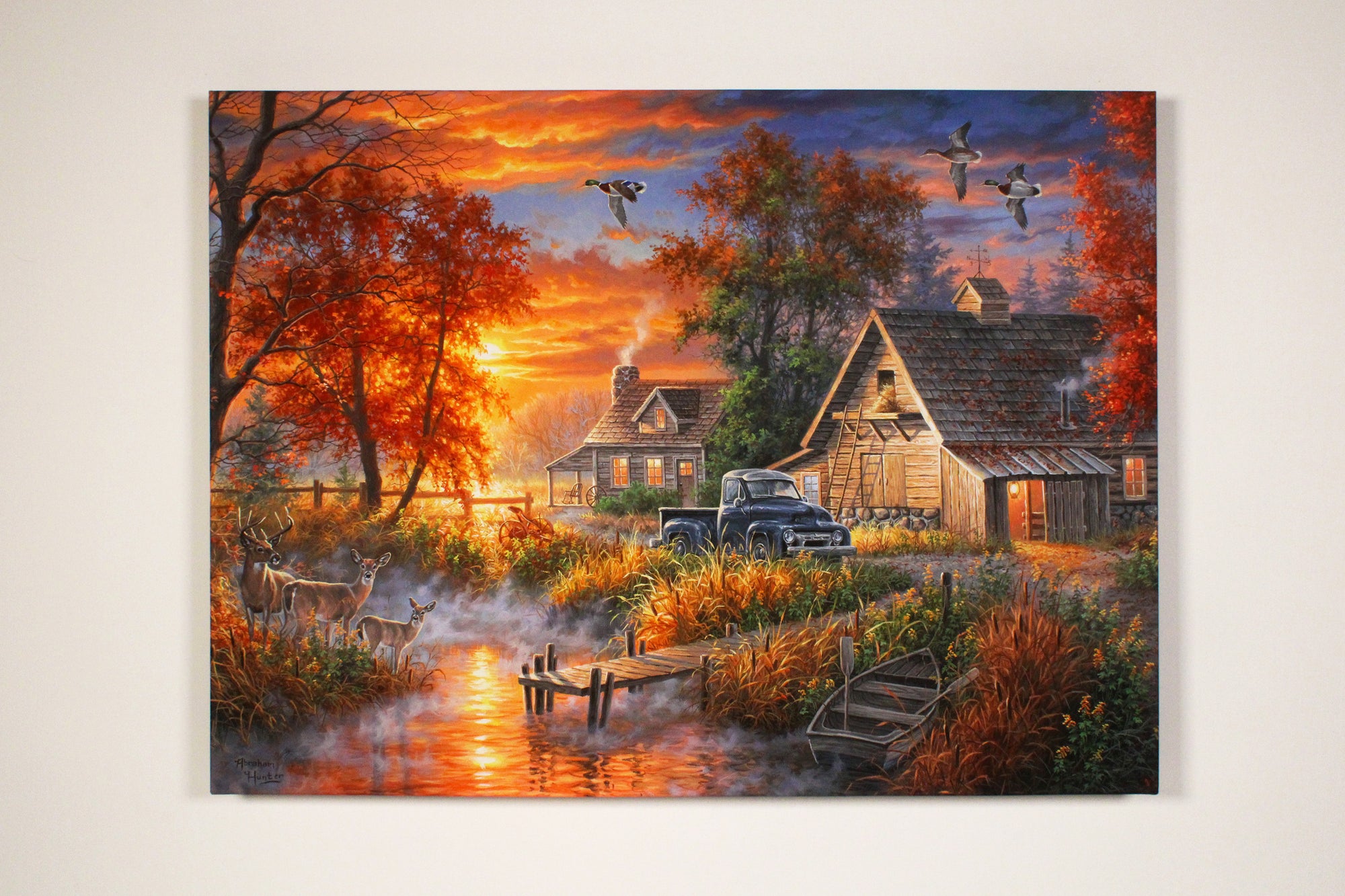 This stunning 18x24 piece captures the essence of an idyllic country farm, complete with a family of deer gracefully grazing on the banks of a tranquil creek bed.  As you gaze at this exquisite scene, you'll notice the soft glow of the LED lights highlighting every detail, from the majestic ducks flying across the sky to the charming old blue truck parked by the rustic barn and farmhouse.