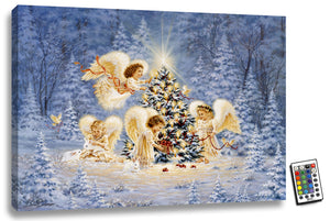This stunning piece features four young angels standing in a snow-covered scene, surrounded by the warmth of a fully illuminated display.  As you gaze upon this enchanting artwork, you'll be captivated by the delicate details of each angel and their peaceful expressions. One of the angels sits in the snow, cradling two bunnies in its lap, while the tree behind them twinkles with the glow of lit candles and shimmering red bead garland.