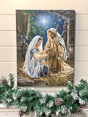 Born In A Manger 18x24 Fully Illuminated LED Art. The nativity with Joseph, Mary, and Jesus staged in a bright room.