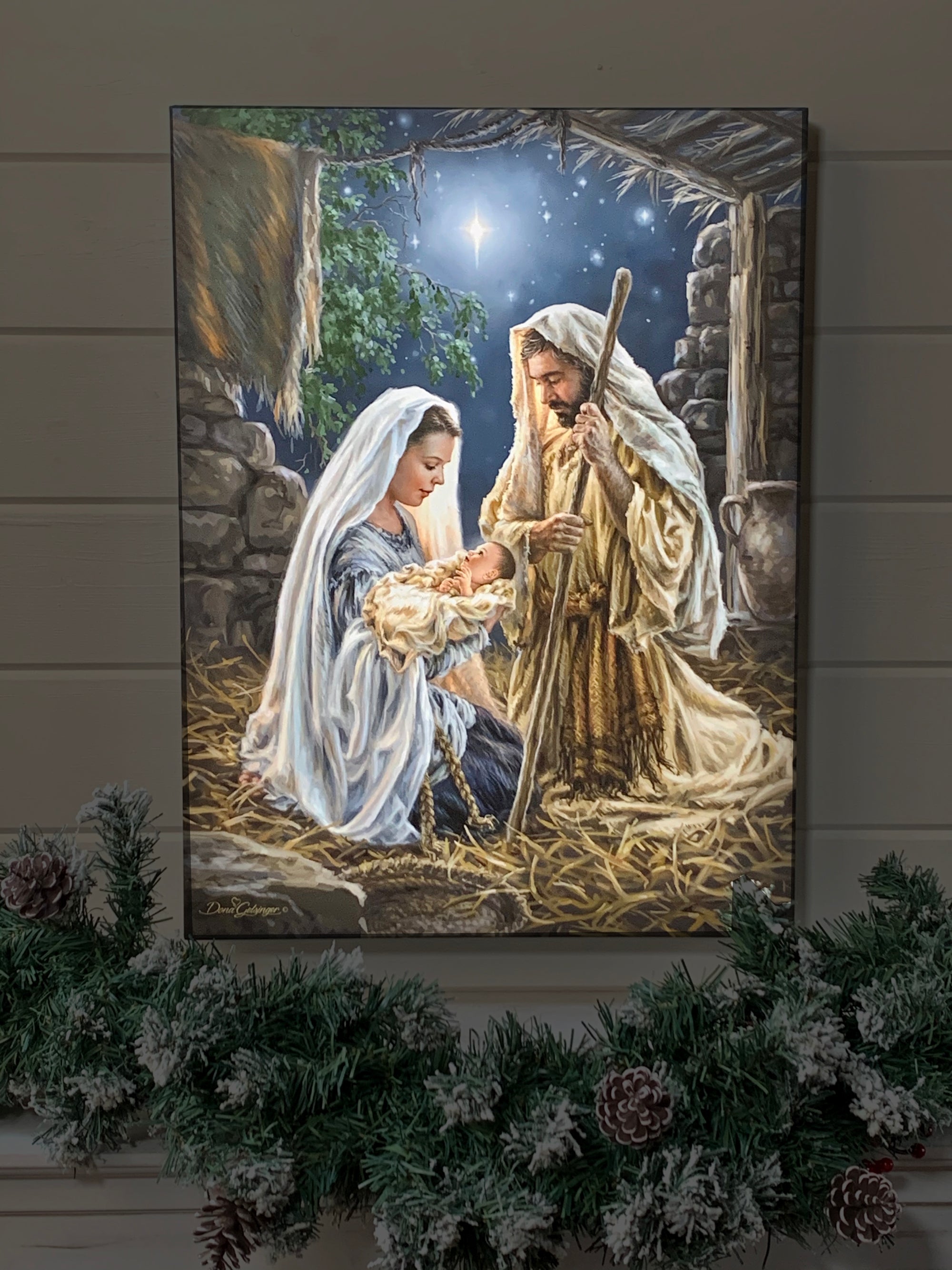 Born In A Manger 18x24 Fully Illuminated LED Art. The nativity with Joseph, Mary, and Jesus staged in a dark room.