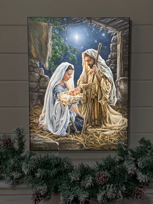 Born In A Manger 18x24 Fully Illuminated LED Art. The nativity with Joseph, Mary, and Jesus staged in a dark room.