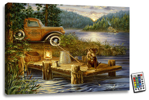  Measuring 18x24, this stunning wall art features a serene dock on a tranquil lake, accompanied by a loyal chocolate lab who gazes intently at the water's surface.  As the sun rises over the majestic mountains in the distance, the dock is illuminated by fully integrated LED lights, creating a warm and inviting ambiance. On the dock, you'll find a charming lantern, fishing pole, and worms, all adding to the peaceful scene.