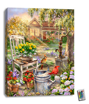 The image features two charming cardinals perched on a watering can amidst a vibrant flower garden, creating a picturesque scene that is sure to captivate your heart.  As you gaze at the art, you'll be transported to a world of lush greenery and blooming flowers. A cozy chair with a flower pot and hand shovel adds a touch of rustic charm, while an old water pump stands nearby.