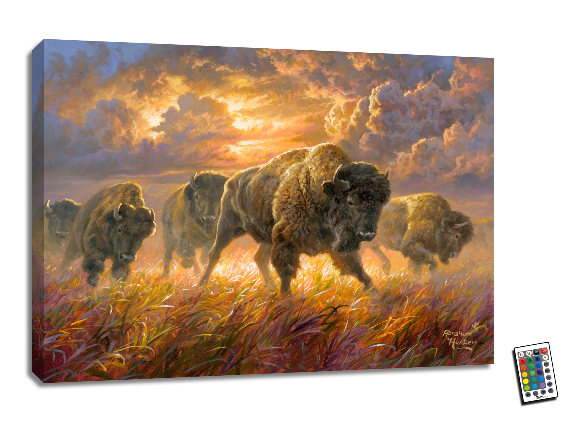 This stunning piece features a large buffalo running through tall grass, surrounded by the golden glow of the sun shining through the clouds above.  The fully illuminated LED lights add a touch of magic, bringing the scene to life with a warm and inviting ambiance.