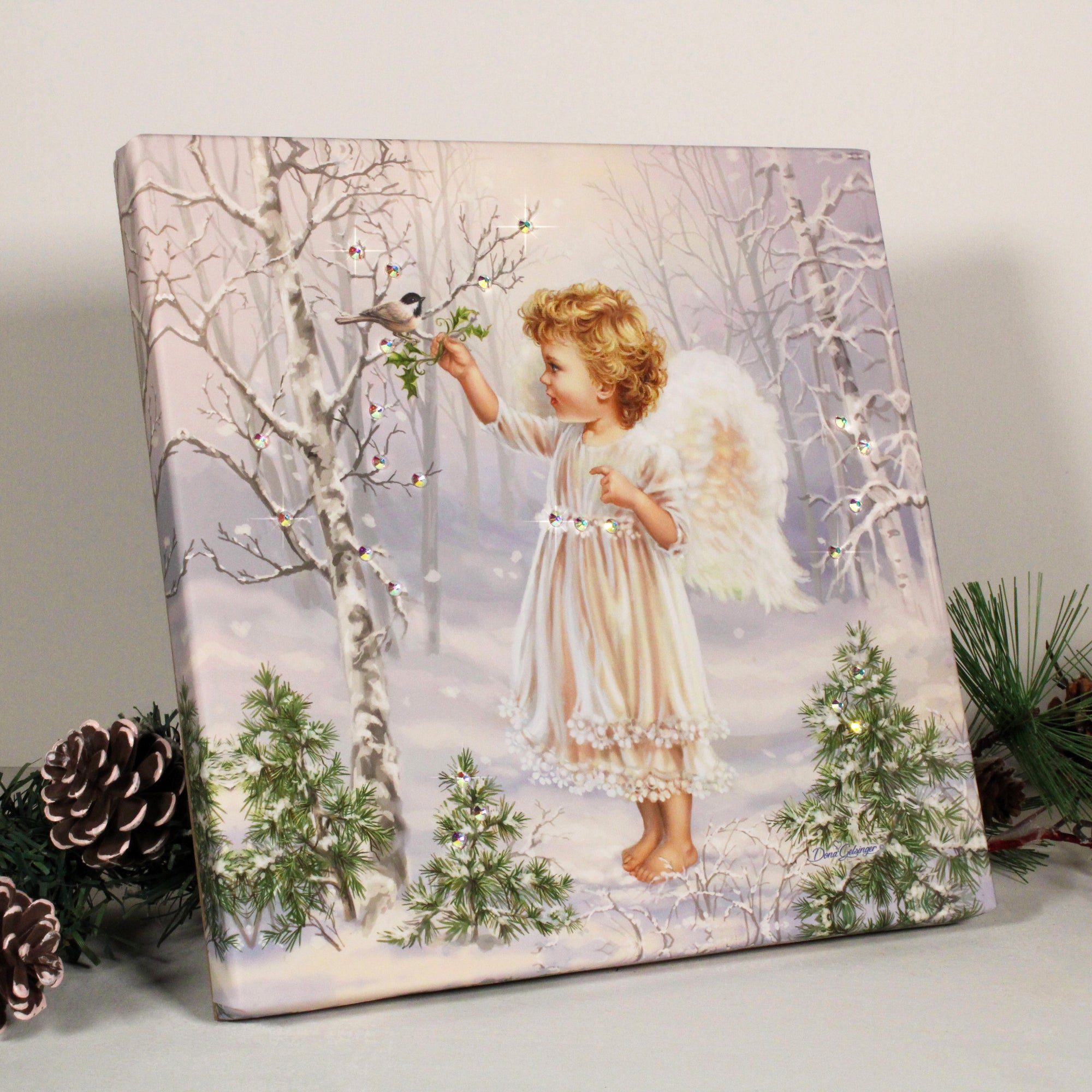 This enchanting print features a young angel standing in a snow-covered forest, reaching up towards a beautiful bird perched atop a tree branch.