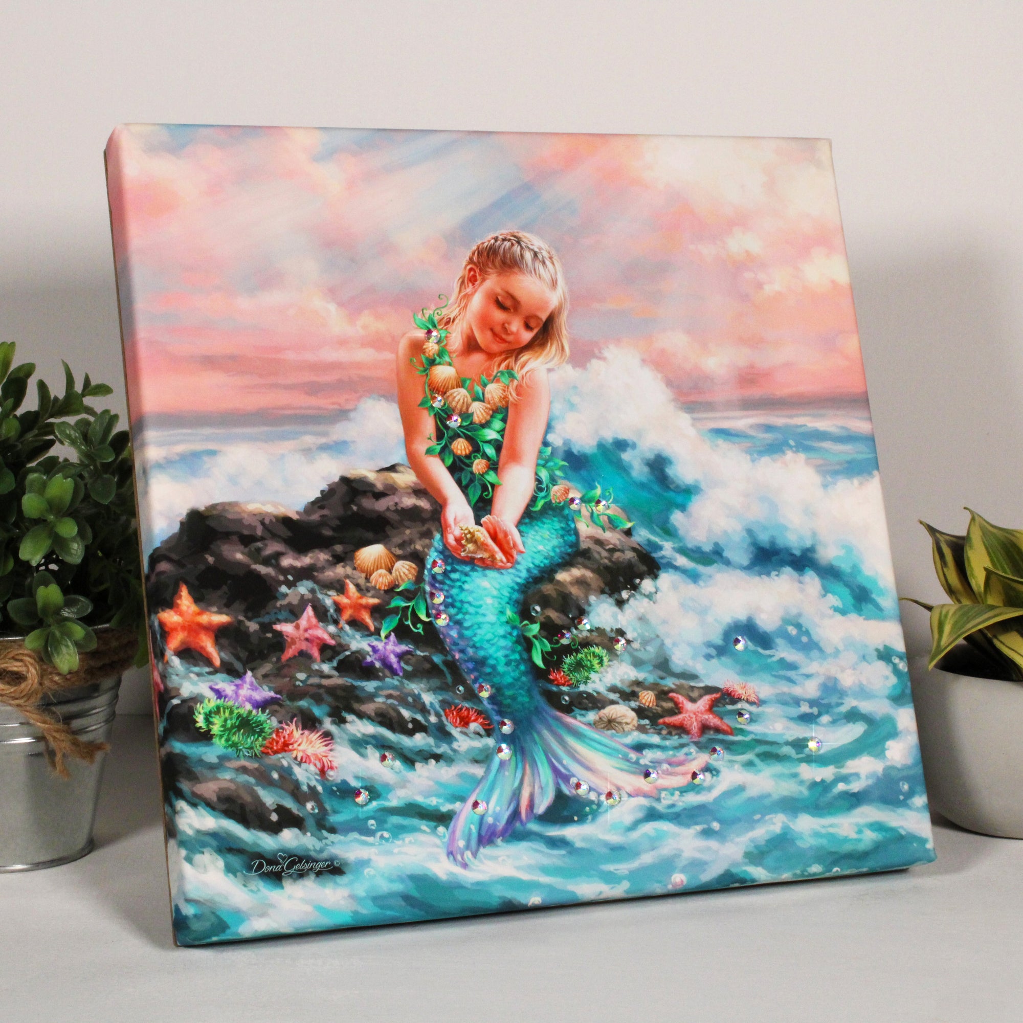 This stunning print features a beautiful young mermaid, gracefully perched upon a rock adorned with shells, starfish, and sea anemones. the waves crash majestically against the rock,