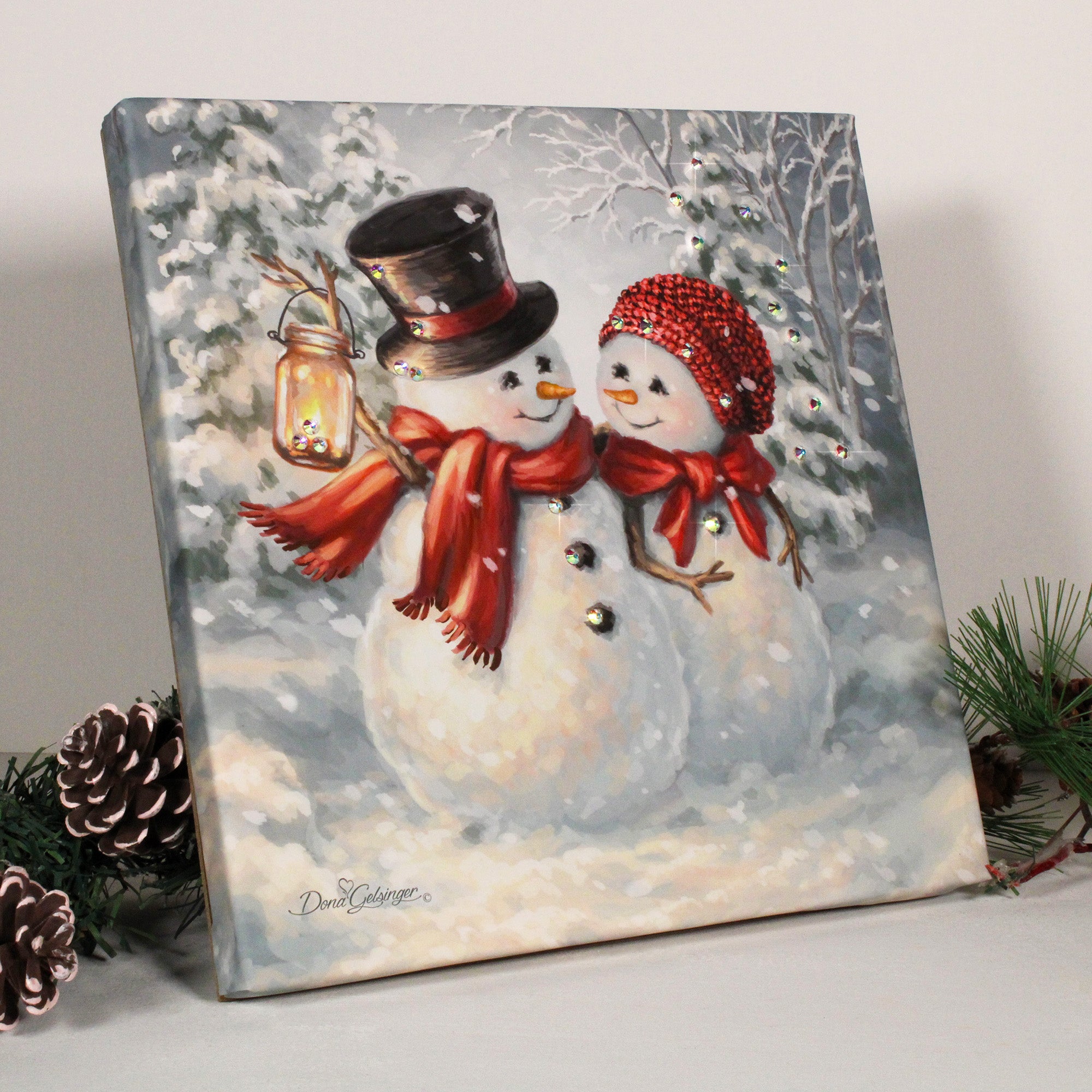 Featuring two adorable snowmen cozied up together, this captivating print captures the essence of love and companionship in a winter wonderland.  With vibrant colors and dazzling crystals that add a touch of glamour, this print will make a stunning addition to your home decor.