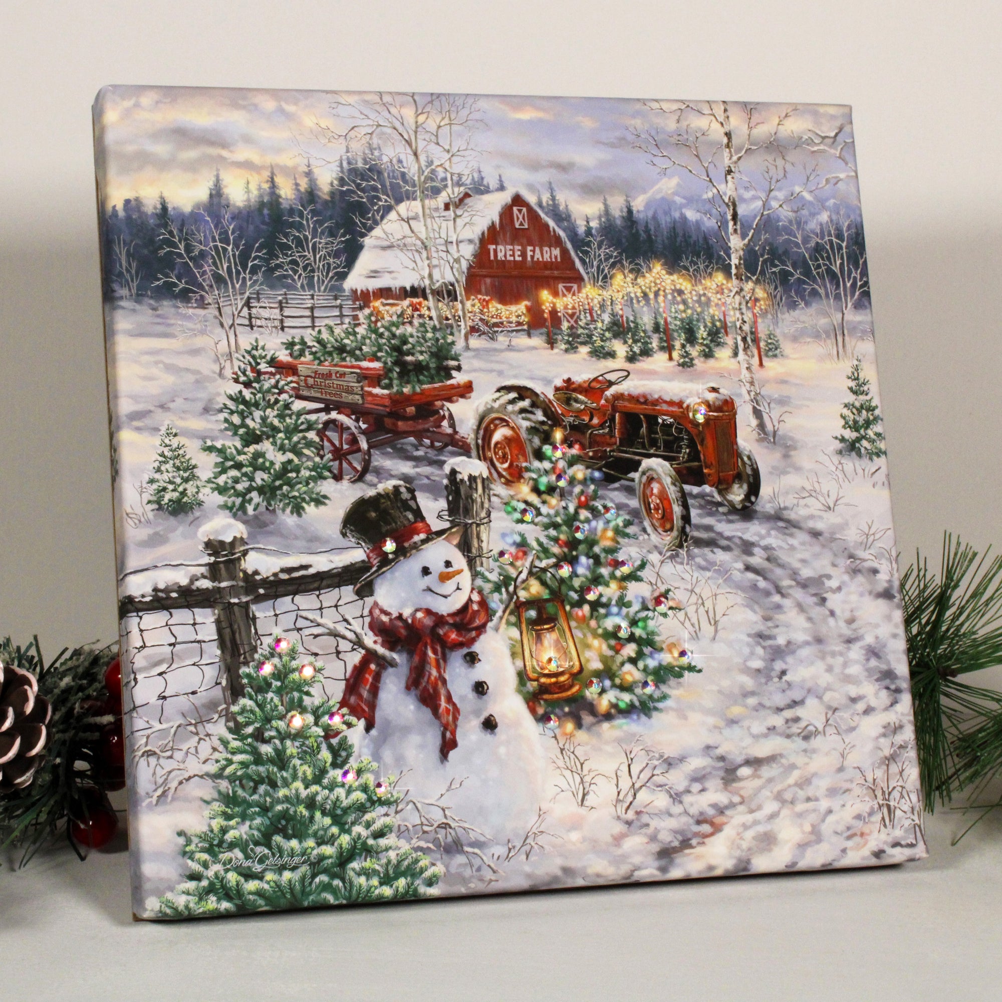 This beautiful artwork captures the essence of winter wonderland with a charming snowman, a glowing Christmas tree, and a rustic red barn. The snow-covered fence and trailer full of fresh-cut trees add to the enchanting scene, making it a perfect addition to your holiday decor.