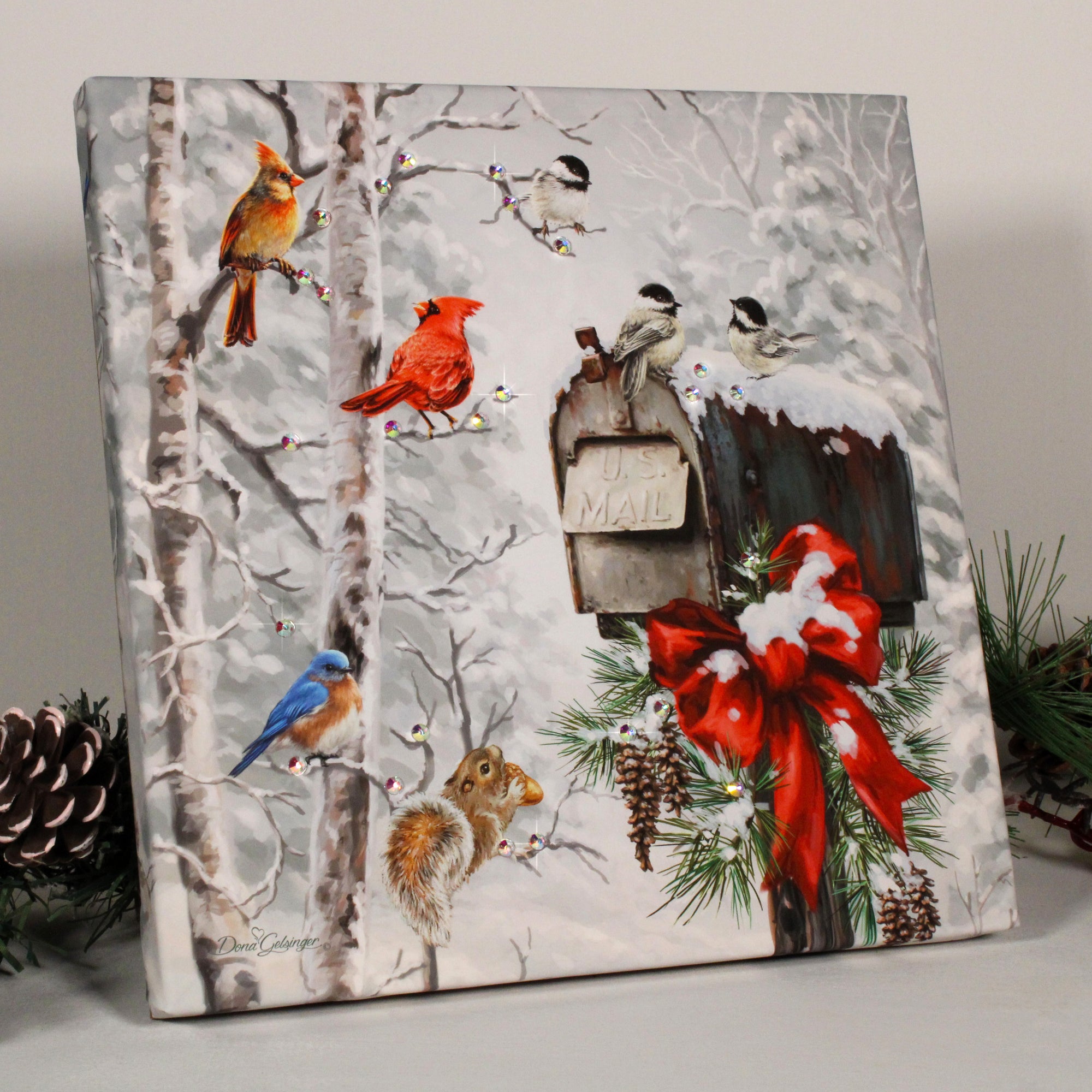 Featuring an enchanting winter scene with a charming mailbox nestled among a flurry of snow, this exquisite print captures the essence of the season. With a delightful cast of feathered friends, as well as a playful squirrel clutching a peanut, it's a scene that truly comes to life.