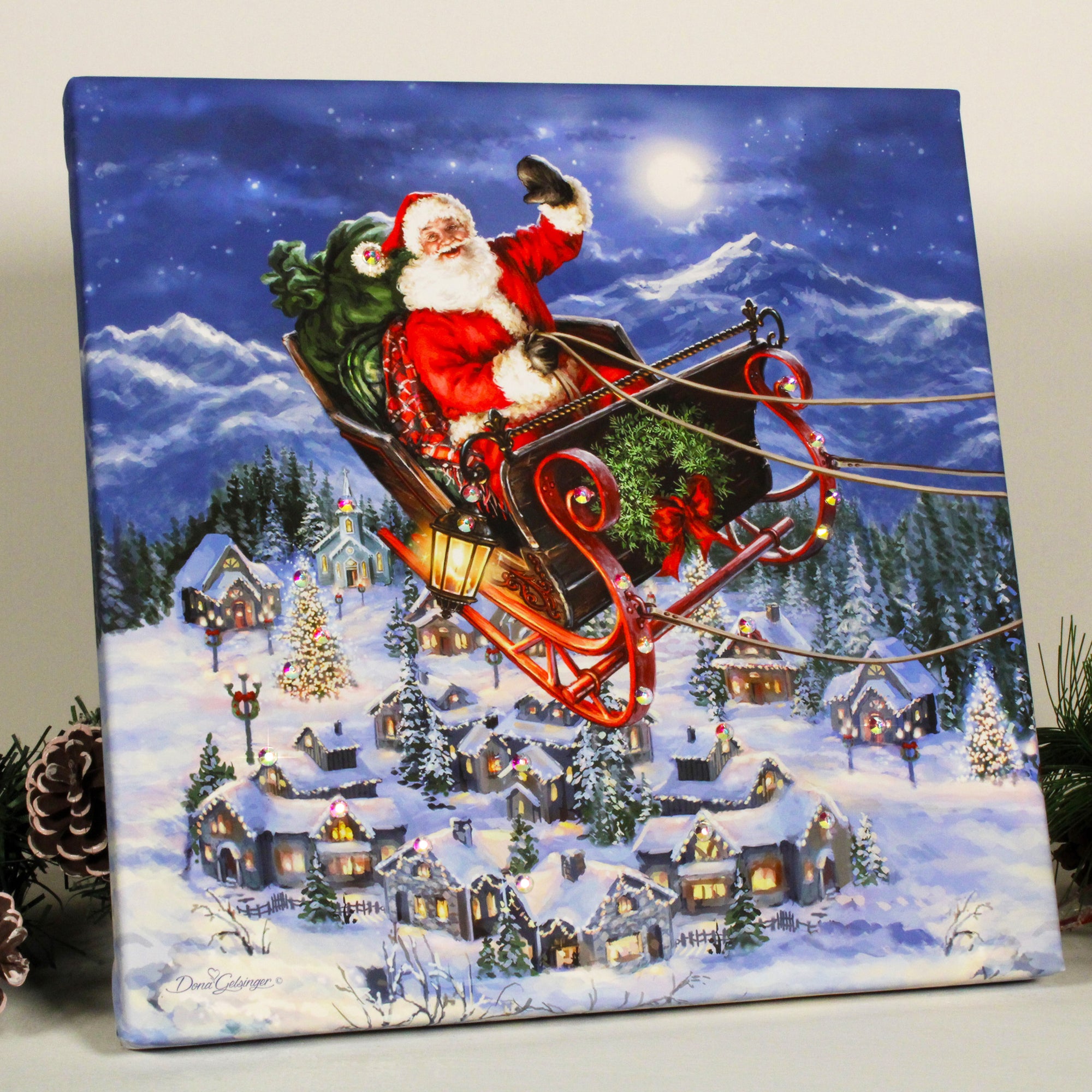  This enchanting print captures the magic of the holiday season with a jolly Santa Claus waving as he flies by on his sleigh, filled to the brim with presents for all the good boys and girls.  As Santa soars through the night sky, a breathtaking snow-covered town can be seen below, complete with cozy houses and twinkling lights that radiate warmth and joy. And just above, a radiant full moon shines down, casting a soft glow over the winter wonderland.