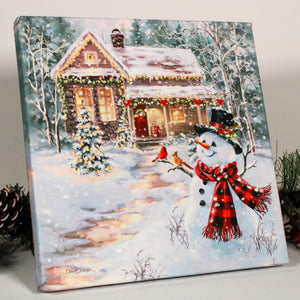 This romantic scene captures the magic of the season with a charming snowman, adorned in a cozy scarf and top hat, holding a lantern that casts a warm and inviting glow. The snowman's wooden arm is the perfect perch for a pair of playful cardinals, adding a touch of whimsy to the enchanting scene.