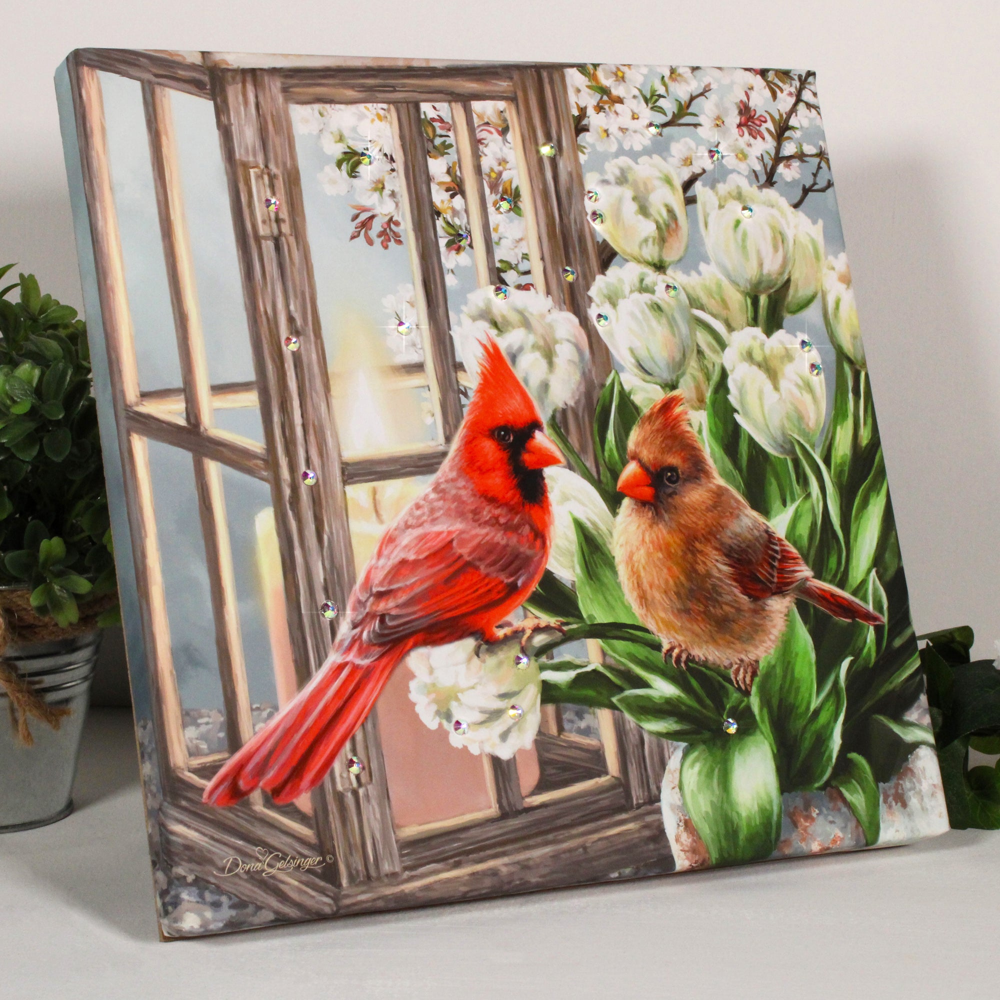 Two magnificent cardinals are perched on delicate white tulips, gazing into each other's eyes with a sense of pure adoration. The sparkling crystals add a touch of glamour and elegance, making this artwork a true feast for the eyes.