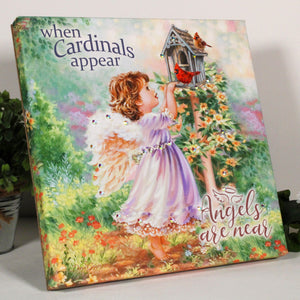  Angels Appear Pizazz Print, featuring a charming young angel gazing at two beautiful cardinals perched atop a cozy birdhouse.
