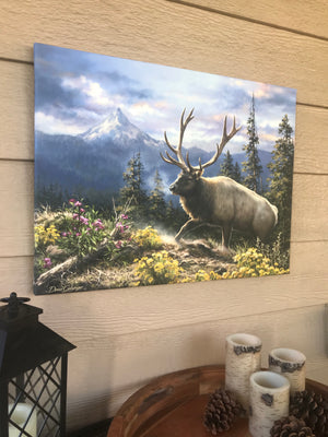  Featuring a majestic elk standing tall on a rugged bluff, this artwork will transport you to the heart of nature's beauty.  The elk is adorned with yellow and pink flowers, adding a touch of whimsy and charm to the scene. The lush forest in the background, with its verdant foliage and towering trees.